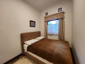 a bedroom with a bed and a window at Kulem Cisitu in Bandung +51 photos