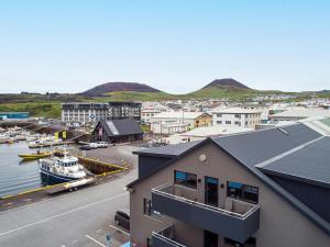 an aerial view of a harbor with boats in the water at Pier Apartments in Vestmannaeyjar +16 photos