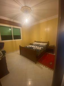 a bedroom with a bed in the middle of a room at Balcon atlantico in Larache