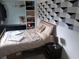 a bedroom with a bed with a black and white wall at The Old Chip Shop in Ilchester