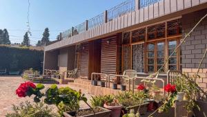 a house with potted plants in front of it at Meizies Home in Shillong