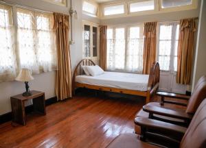 a room with a bed in a room with windows at Meizies Home in Shillong