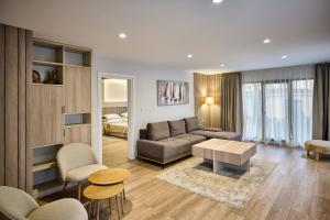 a living room with a couch and a table at Hotel Villa Ekaterina in Vakarel +74 photos