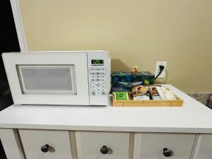 a microwave oven sitting on top of a counter at Moon rooms in Vancouver +12 photos