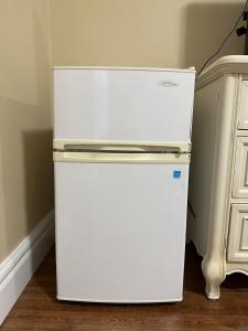 a white refrigerator in the corner of a room at Moon rooms in Vancouver