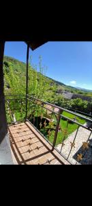 a balcony with a view of a field of grass at Tom House Garden in Tsaghkadzor +5 photos
