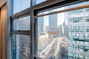 a window with a view of a city at akastay Myeongdong in Seoul