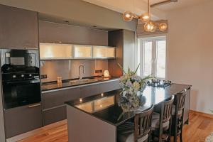 a kitchen with a table with a vase of flowers on it at Stone Heaven Villa in Nuwara Eliya +58 photos
