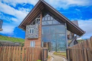 a house with a wooden fence at Stone Heaven Villa in Nuwara Eliya