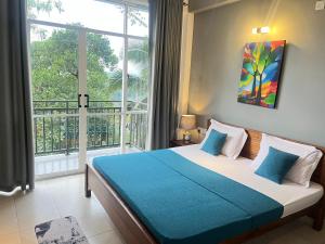 a bedroom with a bed and a large window at kandy hill villa in Kandy