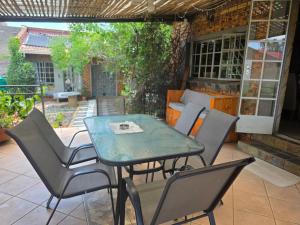 a table and chairs sitting on a patio at At the Well guesthouse in Boksburg