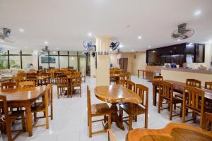a dining room with wooden tables and chairs at El Centro Beach Resort Boracay in Boracay
