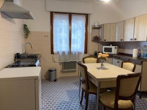 a kitchen with a table and chairs in a kitchen at CA'venezia in Mestre