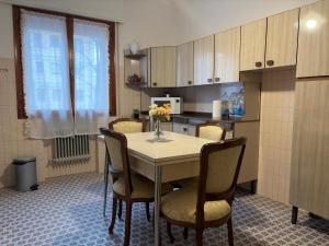 a kitchen with a table with chairs and a microwave at CA'venezia in Mestre