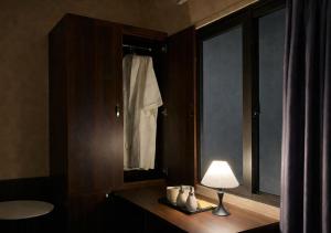 a bathroom with a table with a lamp and a window at Mai Ve Home in Lương Xâm