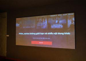 a large screen with a movie projected on a wall at Mai Ve Home in Lương Xâm