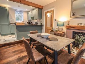 a kitchen and dining room with a table and chairs at West View in Milnthorpe