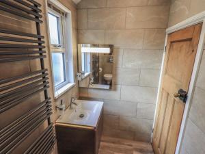 a bathroom with a sink and a mirror at West View in Milnthorpe +31 photos