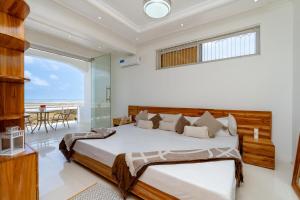 a bedroom with a bed and a view of the ocean at Bahari Beach Front Villa in Mdudu Mkubwa +34 photos