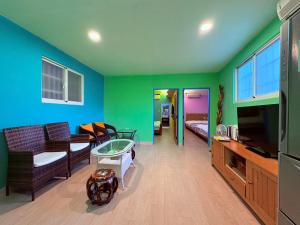 a living room with a couch and a tv at Baisha 31 B&B in Hengchun South Gate +38 photos
