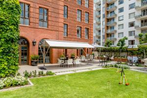 a courtyard with a lawn in front of a building at 54 on Bath, Johannesburg Rosebank in Johannesburg