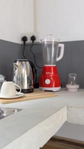 a red blender sitting on top of a counter at Inara Stay in Arugam Bay