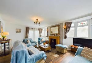 a living room with two couches and a fireplace at Sea Breeze Holiday Chalet in Bridlington