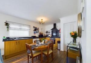 a kitchen with a wooden table and a dining room at Sea Breeze Holiday Chalet in Bridlington