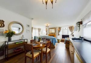 a kitchen and living room with a table and chairs at Sea Breeze Holiday Chalet in Bridlington