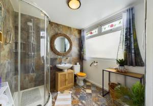 a bathroom with a shower and a toilet and a sink at Sea Breeze Holiday Chalet in Bridlington