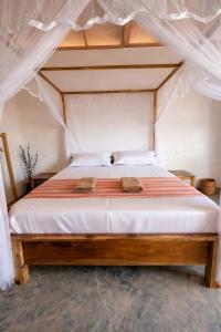 a bedroom with a bed with a canopy at Inara Stay in Arugam Bay