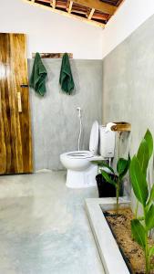 a bathroom with a white toilet in a room at Inara Stay in Arugam Bay +13 photos