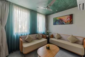 a living room with two couches and a table at Bhagwati luxuria in Indore