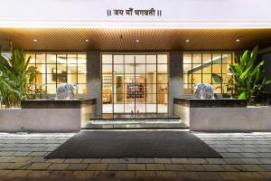 a building with two lion statues in front of it at Bhagwati luxuria in Indore
