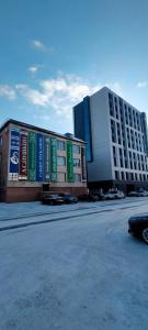 a large building with signs on the side of it at Рахмет in Petropavlovsk