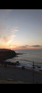 a sunset over the ocean with a group of people at Balcon atlantico in Larache