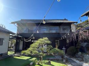 a house with a garden in front of it at stylish japanese beach house in Toyohashi