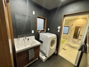 a bathroom with a sink and a large shower at HOTTOSTAY OoGANE in Nagoya +60 photos
