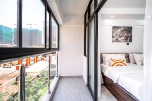 a bedroom with a bed and a large window at Shangri LA Residency in Gatunga