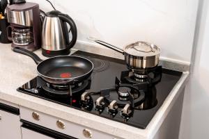 a pot on top of a stove in a kitchen at Shangri LA Residency in Gatunga +14 photos