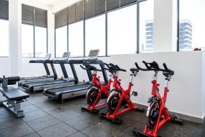a row of red cardio bikes in a gym at Shangri LA Residency in Gatunga