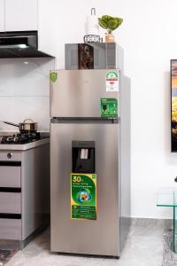 a stainless steel refrigerator with a price sign on it at Shangri LA Residency in Gatunga