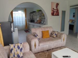 a living room with a couch and a kitchen at countrysidegatewayapartments in Nyeri