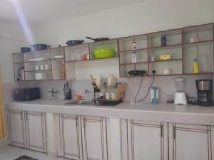 a kitchen with white cabinets and a counter top at countrysidegatewayapartments in Nyeri +3 photos