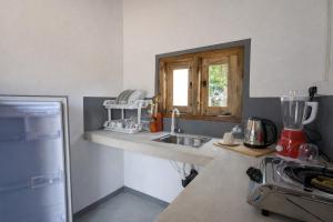 a kitchen with a sink and a counter top at Inara Stay in Arugam Bay