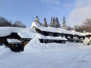 a row of houses covered in snow at Yachi Onsen in Towada