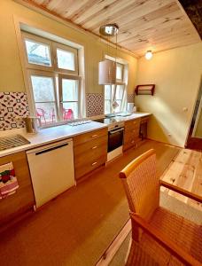 a large kitchen with a counter and a table at Das Brunnenhaus in Tangermünde