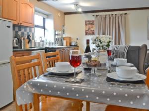 a table with a table cloth on it with wine glasses at The Buttery in Marros