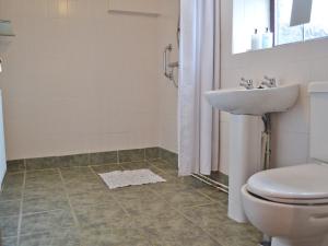 a bathroom with a toilet and a sink at The Buttery in Marros