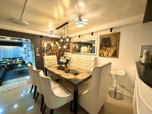 a dining room with a table and white chairs at The White Haven In Clark ENTIRE HOUSE in Angeles +23 photos